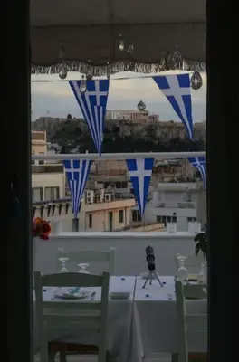 a table with a view of a city through a window at Acropolis View Studio in Monastiraki in Athens
