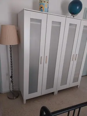 a white cabinet with two doors next to a lamp at Acropolis View Studio in Monastiraki in Athens