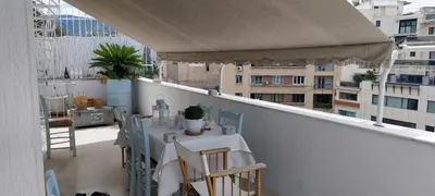 a balcony with a table and chairs on a balcony at Acropolis View Studio in Monastiraki in Athens