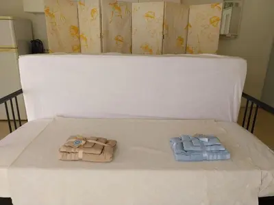 two towels are sitting on a white bed at Acropolis View Studio in Monastiraki in Athens