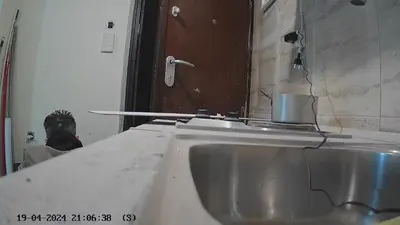 a sink in a bathroom with a man in the mirror at Kallithea Charokopou in Athens