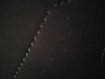 a close up of a zipper of a black tie at Petralona in Athens