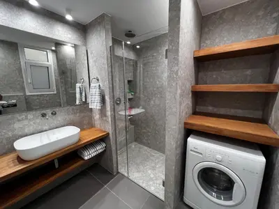 a bathroom with a washing machine and a washer at Stunning View Zeas Marina - 1 bedroom in Piraeus