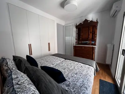 a bedroom with a bed and a wooden dresser at Stunning View Zeas Marina - 1 bedroom in Piraeus