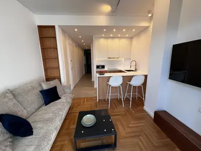 a living room with a couch and a table at Stunning View Zeas Marina - 1 bedroom in Piraeus