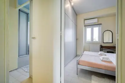 a bedroom with a bed and a mirror and a window at Acropolis Penthouse with 50mbps WIFI in Athens