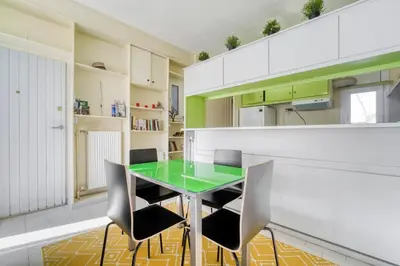 a kitchen with a green table and chairs at Acropolis Penthouse with 50mbps WIFI in Athens