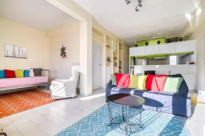 a living room with a couch and a table at Acropolis Penthouse with 50mbps WIFI in Athens