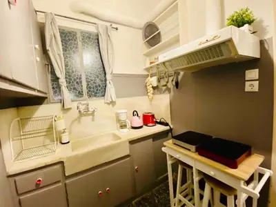 a small kitchen with a sink and a microwave at Aegli of Acropolis - 50mbps wifi in Athens