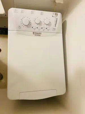 a white washing machine sitting on top of a counter at Aegli of Acropolis - 50mbps wifi in Athens