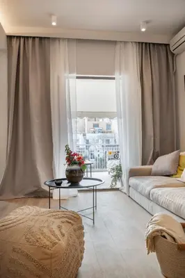 a living room with a couch and a table at Lykavittos hill- penthouse in Athens