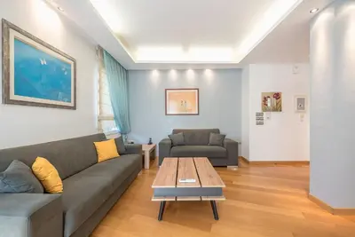 a living room with a couch and a coffee table at Agios Ioannis Metro station - Comfy Apartment in Athens