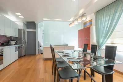 a dining room with a glass table and chairs at Agios Ioannis Metro station - Comfy Apartment in Athens