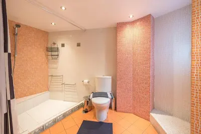 a bathroom with a toilet and a tub and a shower at Agios Ioannis Metro station - Comfy Apartment in Athens