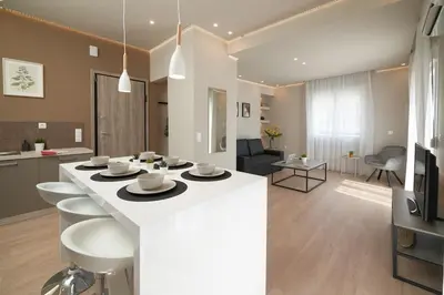 a kitchen and living room with a large white counter top at Athens city apartment B 100Mbps wifi in Athens