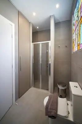 a bathroom with a toilet and a glass shower at Athens city apartment B 100Mbps wifi in Athens