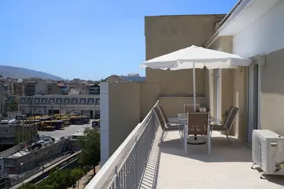 a balcony with an umbrella and a table and chairs at Athens city apartment B 100Mbps wifi in Athens