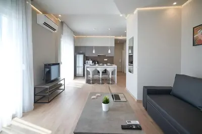 a living room with a couch and a table at Athens city apartment B 100Mbps wifi in Athens