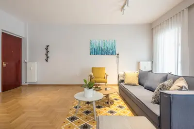 a living room with a couch and a table at Luxury Athens Living 3BR with Balcony in Athens