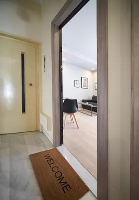 a door leading into a living room with a welcome mat at Athens city 2 bedrooms apartment A 100Mbps wifi in Athens