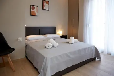 a bedroom with a large bed with towels on it at Athens city 2 bedrooms apartment A 100Mbps wifi in Athens