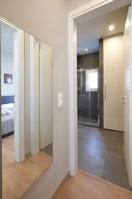 a hallway with a mirror and a bedroom at Athens city 2 bedrooms apartment A 100Mbps wifi in Athens