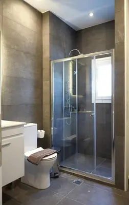a bathroom with a toilet and a glass shower at Athens city 2 bedrooms apartment A 100Mbps wifi in Athens