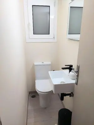 a bathroom with a white toilet and a sink at Beautiful apartment in Acropolis in Athens