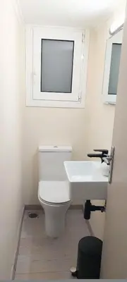 a bathroom with a white sink and a toilet at Beautiful apartment in Acropolis in Athens