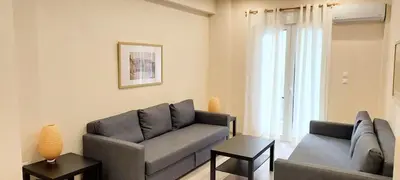 a living room with a couch and a chair at Beautiful apartment in Acropolis in Athens