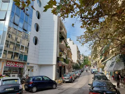 a street with cars parked on the side of a building at Beautiful apartment in Acropolis in Athens