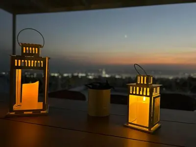 three lanterns sitting on a table with a view at Glyfada sunset Apartment in Athens