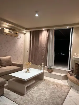 a living room with a couch and a table at Glyfada sunset Apartment in Athens