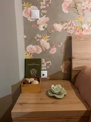 a bed with a book and a box on a table at Glyfada sunset Apartment in Athens