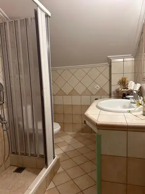 a bathroom with a sink and a shower at Glyfada sunset Apartment in Athens