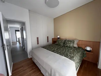 a bedroom with a large bed and a hallway at Stunning View Zeas Marina - 2 bedrooms in Piraeus