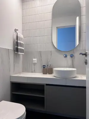 a white bathroom with a sink and a mirror at Stunning View Zeas Marina - 2 bedrooms in Piraeus