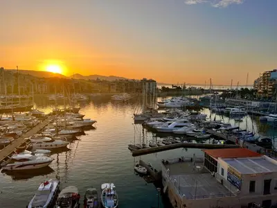 a group of boats docked in a marina at sunset at Stunning View Zeas Marina - 2 bedrooms in Piraeus