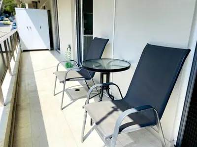 a row of chairs and a table on a balcony at Karyatis - Apartment on the road of history in Athens
