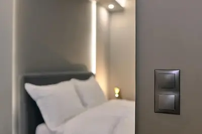 a bedroom with a white bed and a mirror at Live in Athens City center flat in Athens