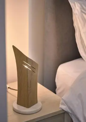 a lamp on a table next to a bed at Live in Athens City center flat in Athens