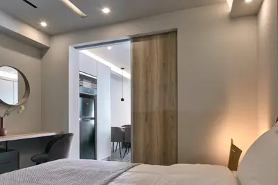 a bedroom with a bed and a desk and a mirror at Live in Athens City center flat in Athens