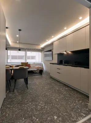 a kitchen and dining room with a table and a couch at Live in Athens City center flat in Athens