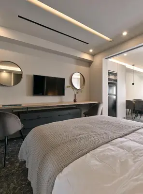 a bedroom with a bed and a desk with a television at Live in Athens City center flat in Athens