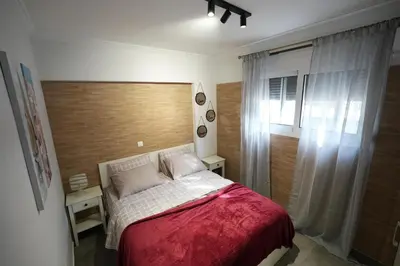 a small bedroom with a bed and a window at Lovely Front Garden 2 BDRM Nea Smyrni in Athens
