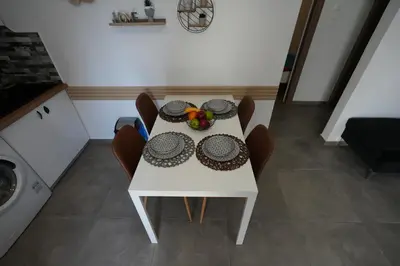 a white table with a bowl of fruit on it at Lovely Front Garden 2 BDRM Nea Smyrni in Athens