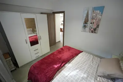 a bedroom with a bed and a large mirror at Lovely Front Garden 2 BDRM Nea Smyrni in Athens
