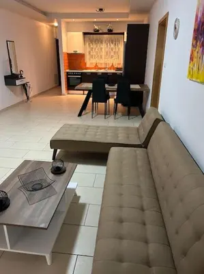 a living room with a couch and a table at Κεντρικό διαμέρισμα στην Αθηνα in Athens