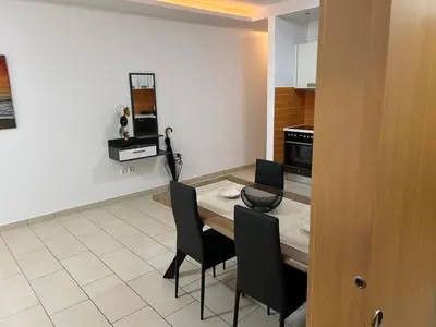 a kitchen with a table and chairs in a room at Κεντρικό διαμέρισμα στην Αθηνα in Athens