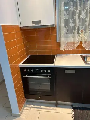 a kitchen with a black stove and a sink at Κεντρικό διαμέρισμα στην Αθηνα in Athens